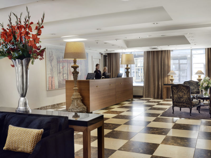 In the elegant yet cozy foyer, guests can relax by the fireplace and browse leisurely through the daily papers.